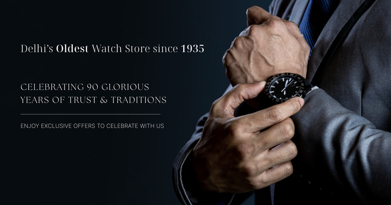 Person adjusting a watch with text celebrating a watch store's 90-year history.